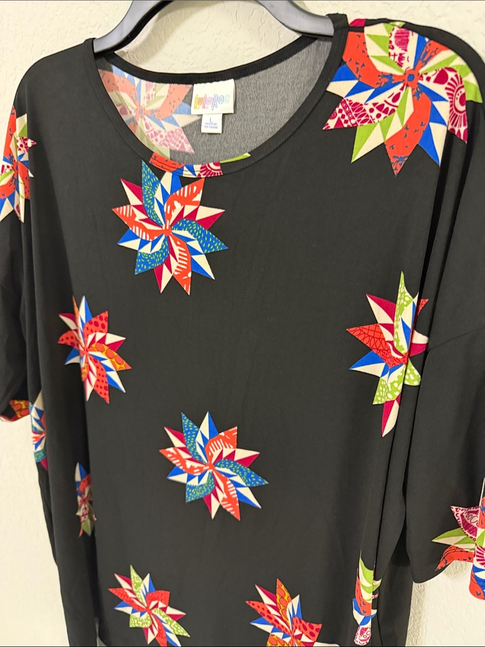 LuLaRoe Black Tunic Tee with Colorful Starburst print